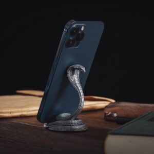 A modern smartphone elegantly displayed on a cobra-shaped stand, adding style to any desk.